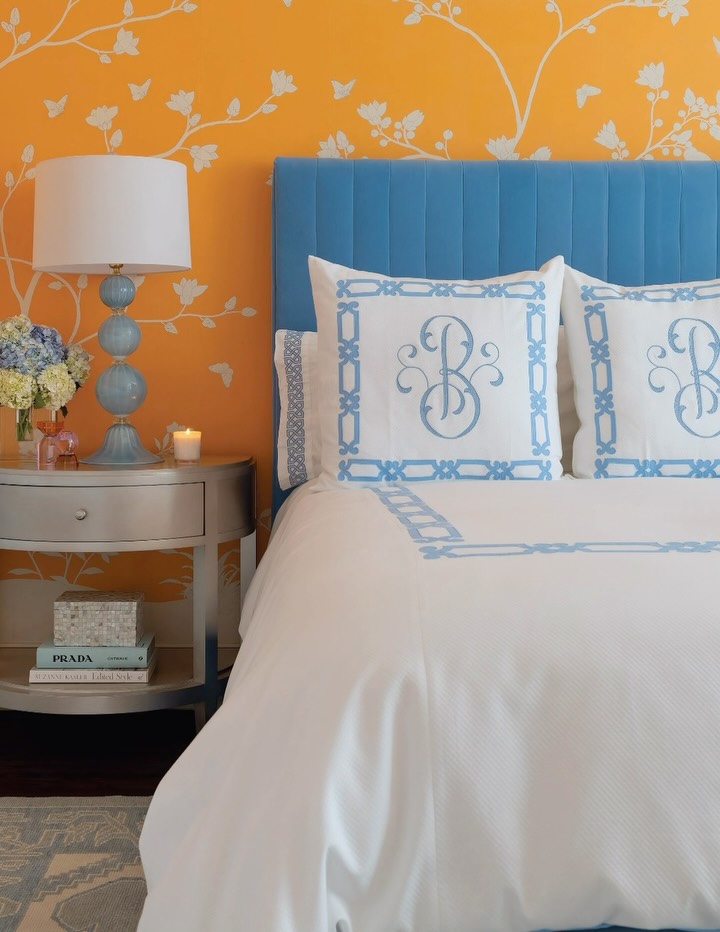 There’s something about a beautiful guest bedroom that makes you want to linger just a little longer.🦋Wrapped in bespoke hand-painted @graciestudio wallpaper in the sweetest shade of orange sorbet, layered with a cerulean blue bed and crisp white @leontinelinens bedding, this space was designed to feel equal parts joyful and serene. A gentle reminder that the most memorable rooms aren’t just beautiful—they make you feel something. Calm. Rested. Welcomed. Inspired.This guest retreat was created to do exactly that.